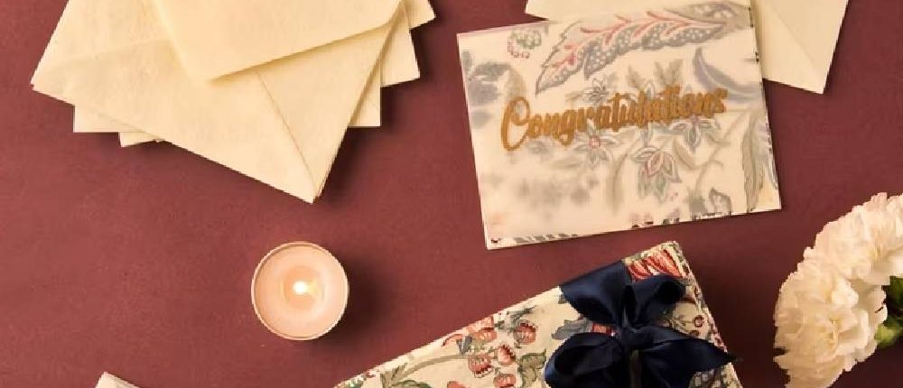 Gift envelopes and cards on a dark red table